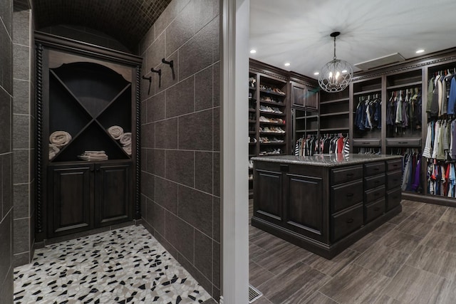 wine area with recessed lighting and an inviting chandelier