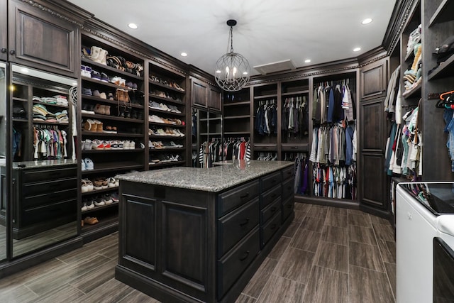 walk in closet with wood tiled floor and a notable chandelier