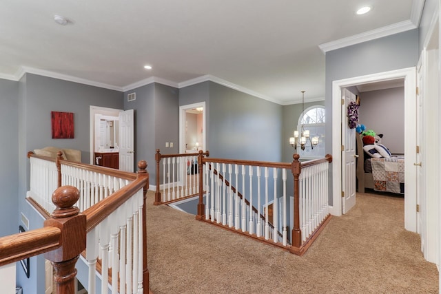 hallway featuring a chandelier, visible vents, an upstairs landing, carpet, and crown molding