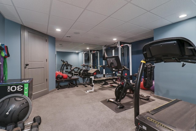 exercise room featuring a paneled ceiling, baseboards, carpet flooring, and recessed lighting