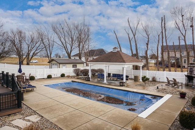 view of swimming pool with a fenced backyard, a fenced in pool, a patio, and a gazebo