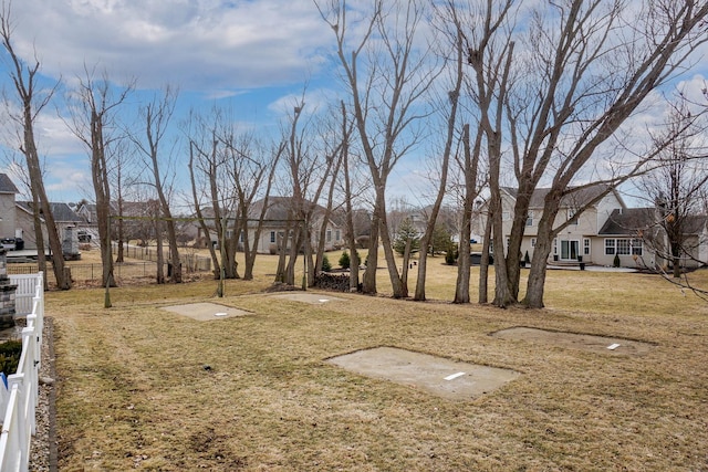 view of yard featuring a residential view and fence