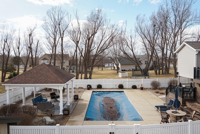 view of pool featuring a patio area, a fenced backyard, a fenced in pool, and a gazebo