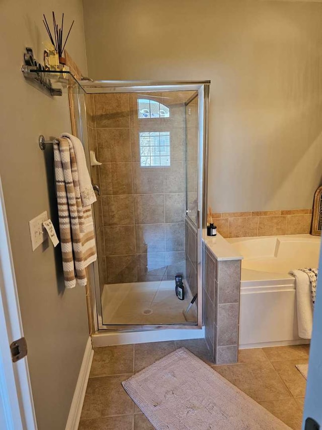 bathroom with tile patterned floors and plus walk in shower