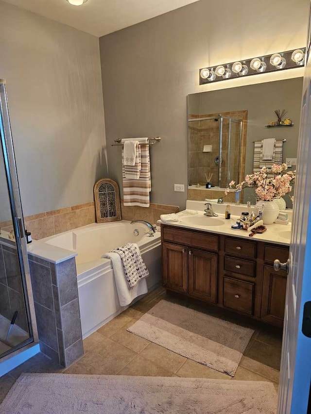 bathroom featuring shower with separate bathtub, tile patterned flooring, and vanity