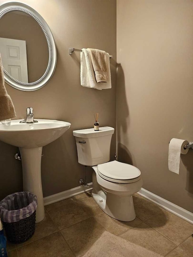 bathroom with tile patterned floors and toilet