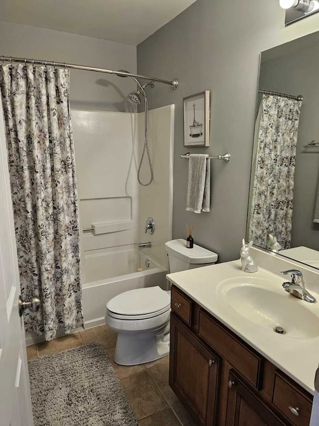 full bathroom featuring toilet, tile patterned floors, shower / tub combo with curtain, and vanity