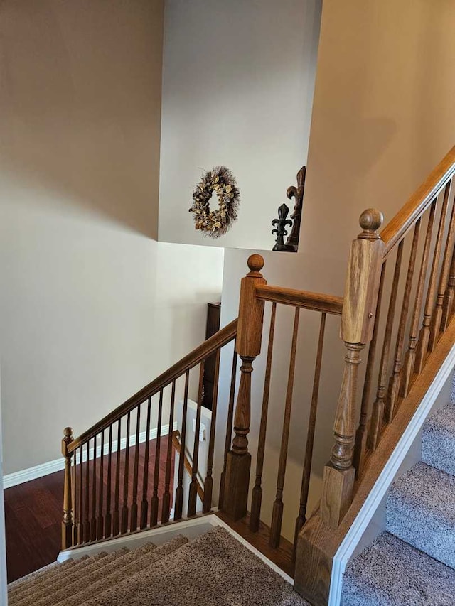 staircase featuring wood-type flooring