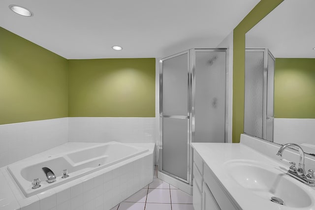 bathroom featuring tile patterned flooring, vanity, and separate shower and tub