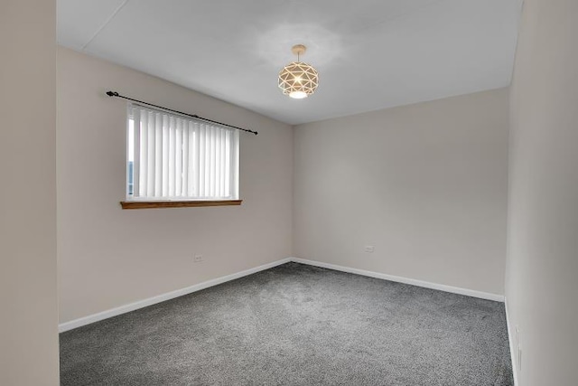 unfurnished room featuring dark colored carpet