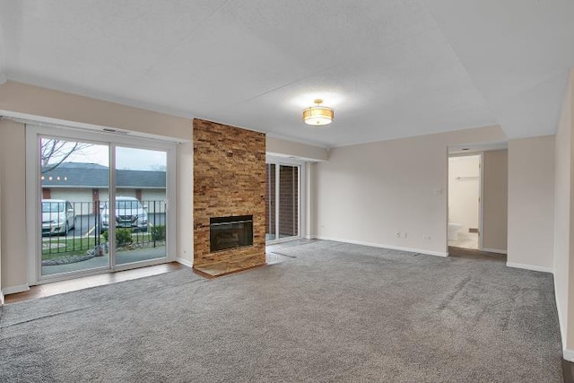 unfurnished living room with carpet flooring and a fireplace