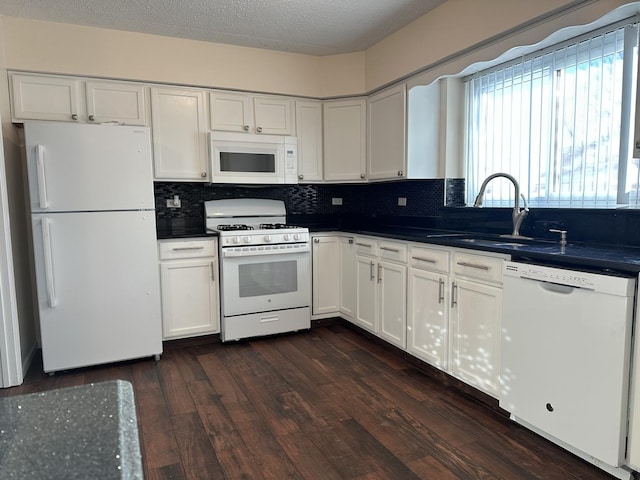 kitchen featuring sink, backsplash, dark hardwood / wood-style flooring, white cabinets, and white appliances