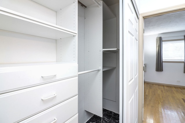 walk in closet featuring hardwood / wood-style floors