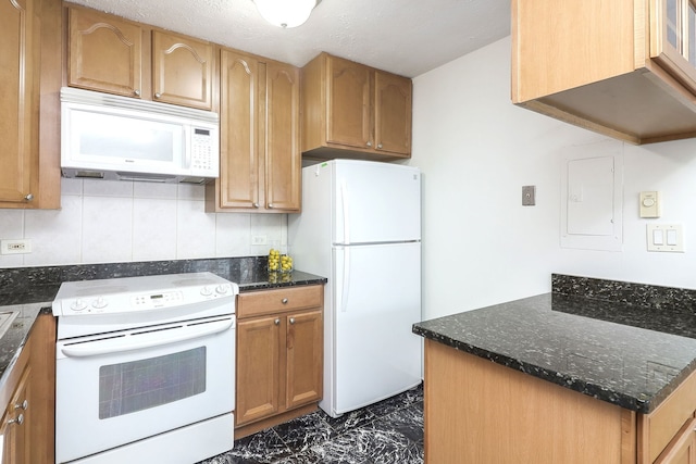 kitchen with white appliances, dark stone counters, electric panel, and backsplash