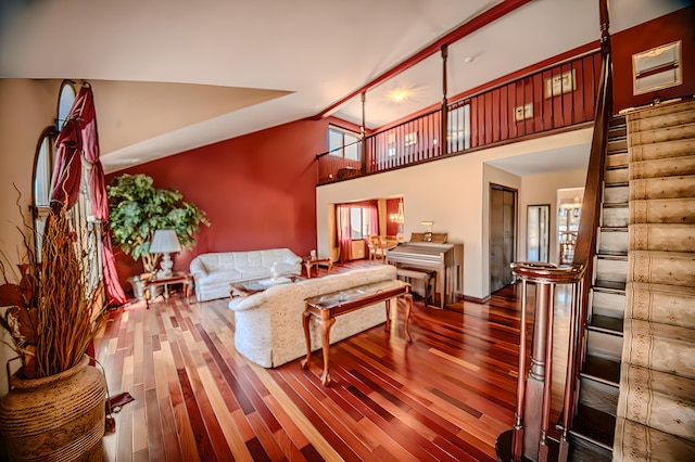 living room with high vaulted ceiling and wood finished floors