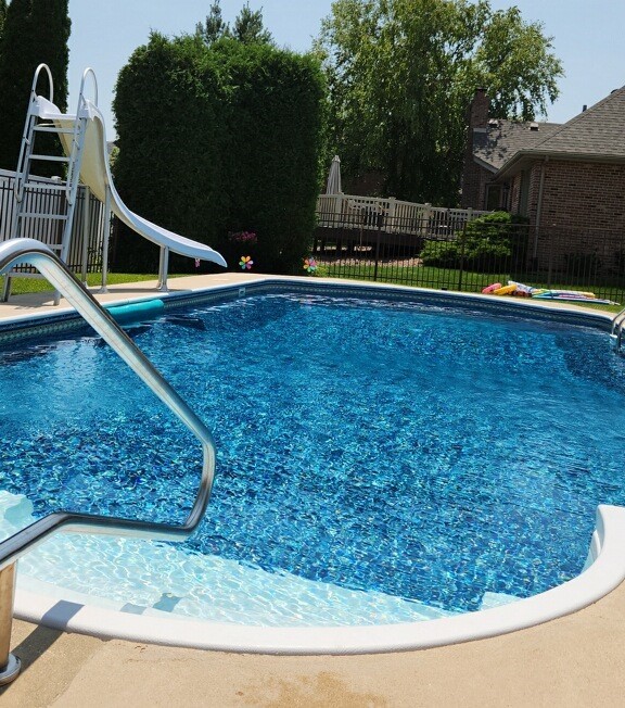 view of pool featuring a fenced in pool, a water slide, and fence