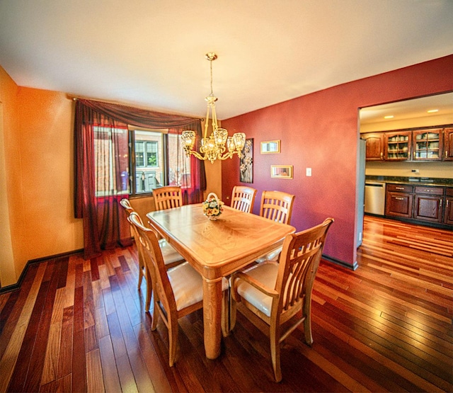 dining area with a notable chandelier, baseboards, and dark wood-style flooring