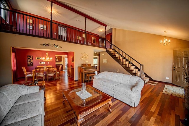 living room featuring stairs, wood finished floors, and a chandelier