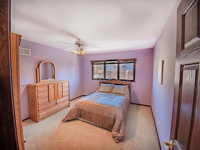 bedroom with a ceiling fan, visible vents, carpet floors, and baseboards