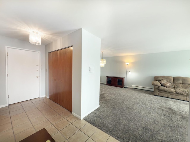 unfurnished living room featuring baseboard heating, a chandelier, and tile patterned flooring