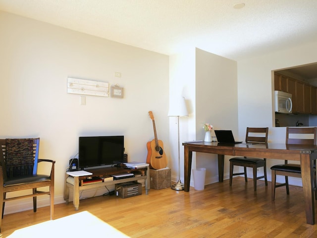 home office with baseboards and light wood-style floors