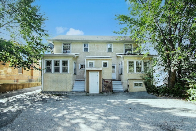 view of front of property featuring fence and stucco siding