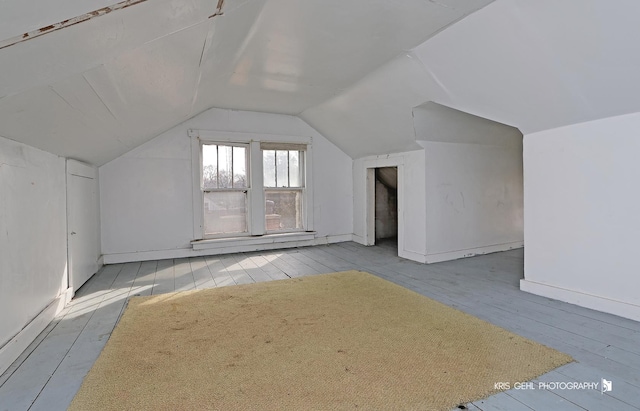 additional living space with lofted ceiling and wood-type flooring