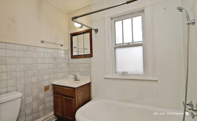 full bath featuring toilet, tile walls, and vanity