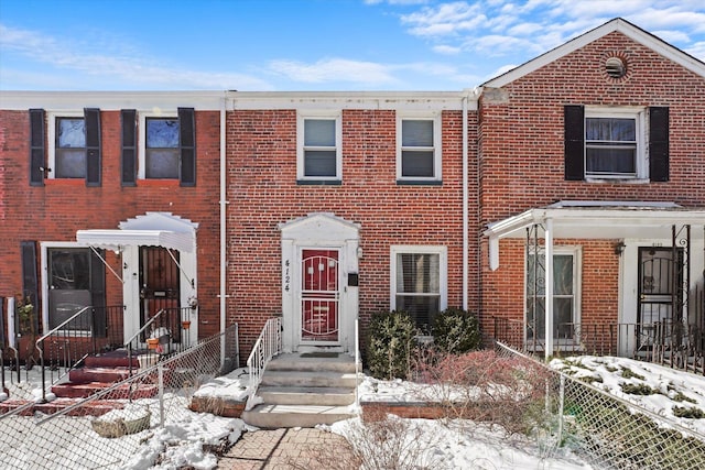 multi unit property featuring fence and brick siding