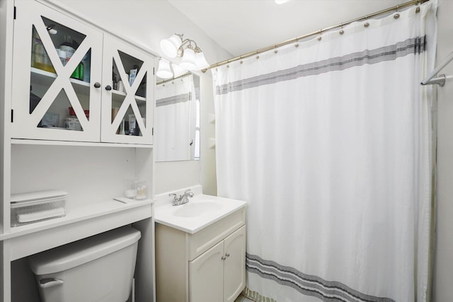 full bathroom with toilet and vanity