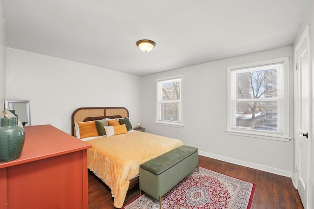 bedroom featuring dark wood finished floors and baseboards