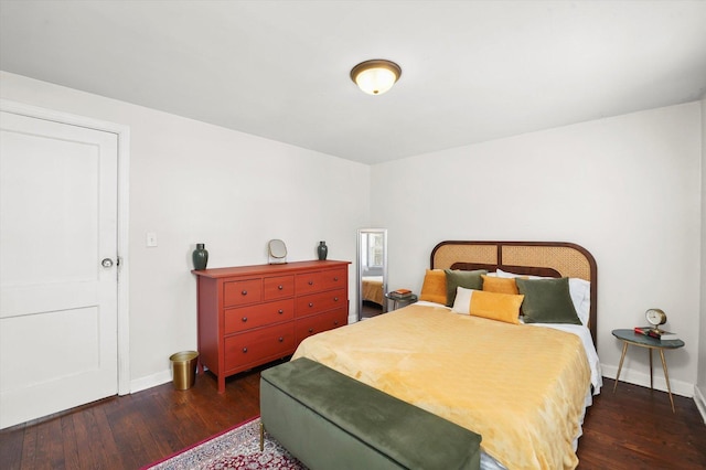 bedroom featuring dark wood-type flooring and baseboards