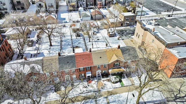 snowy aerial view with a residential view