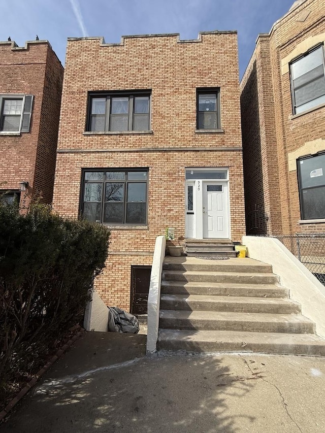 view of exterior entry with brick siding