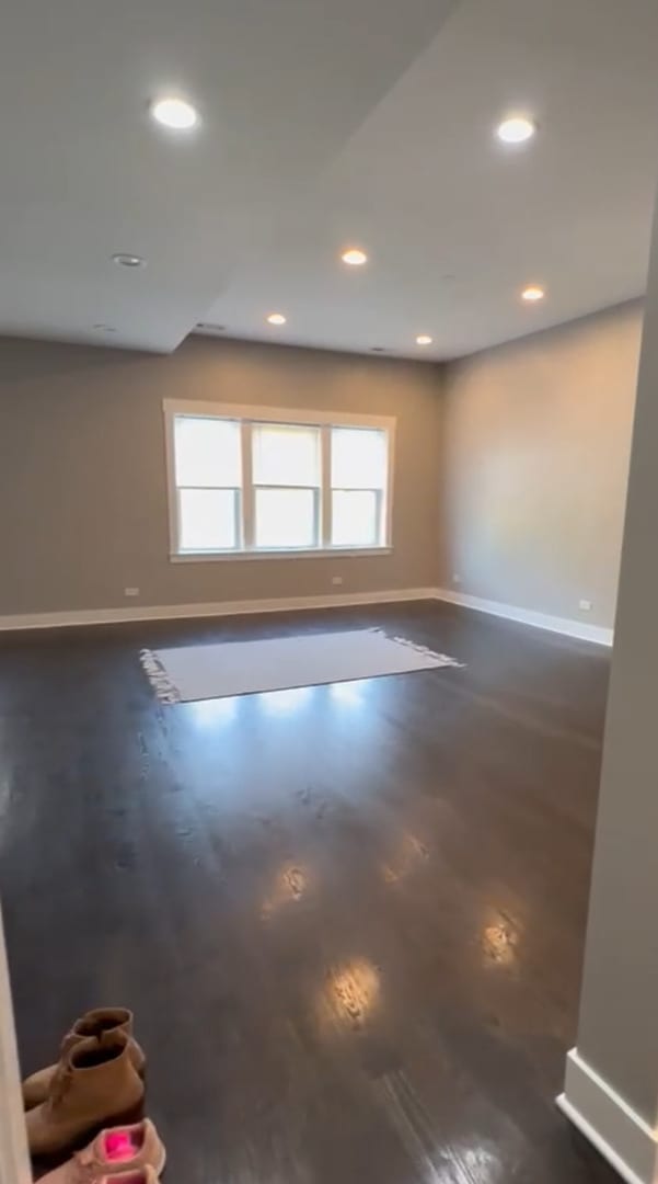 spare room featuring concrete flooring, recessed lighting, and baseboards