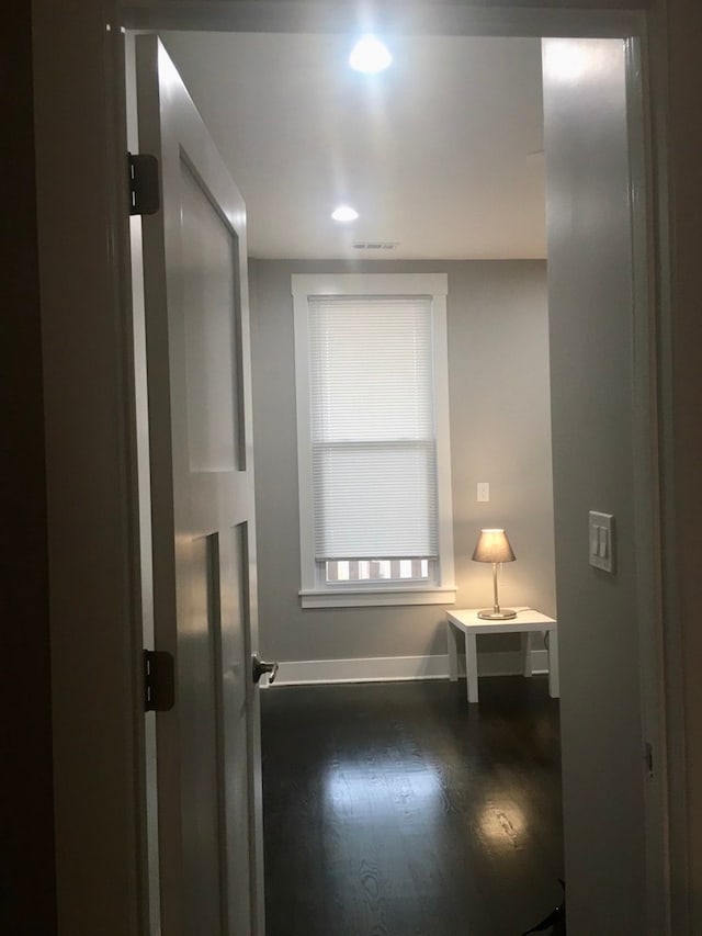 interior space featuring baseboards and wood finished floors