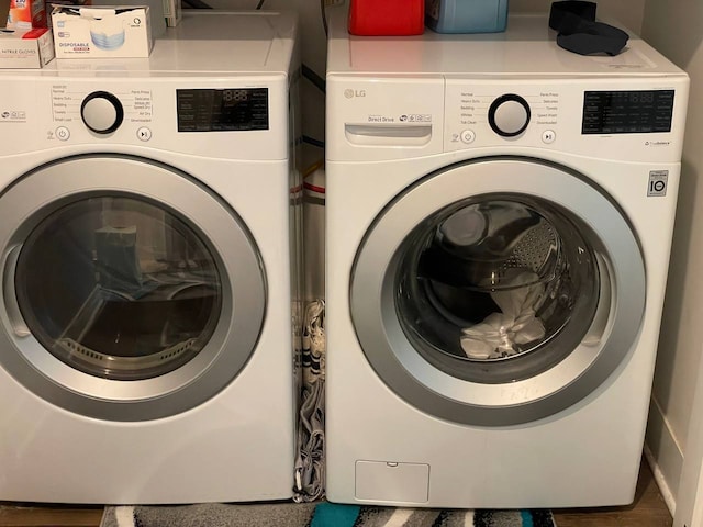 clothes washing area featuring laundry area and washer and dryer