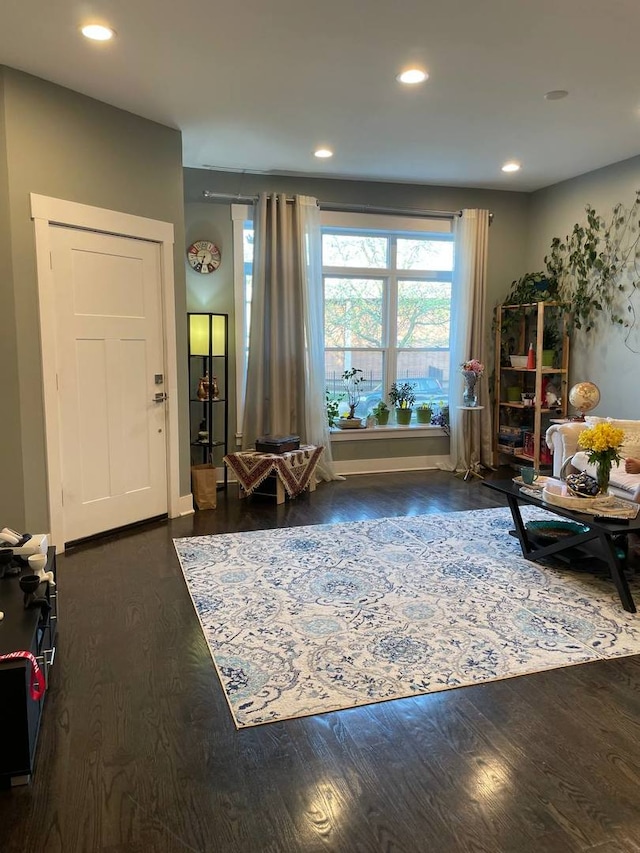 sitting room featuring baseboards, wood finished floors, and recessed lighting