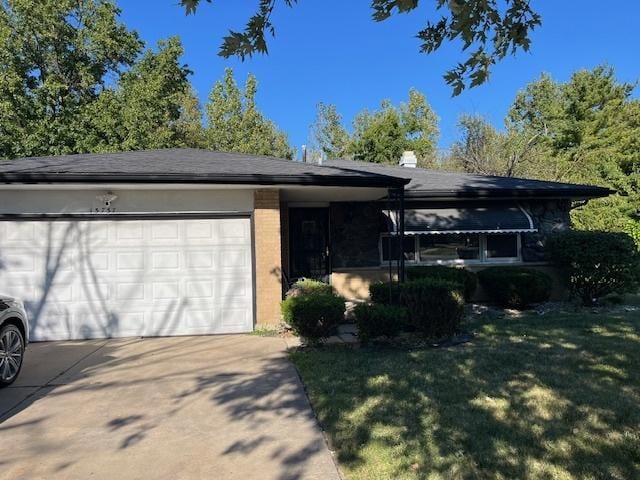 ranch-style house with brick siding, a front lawn, concrete driveway, a chimney, and an attached garage