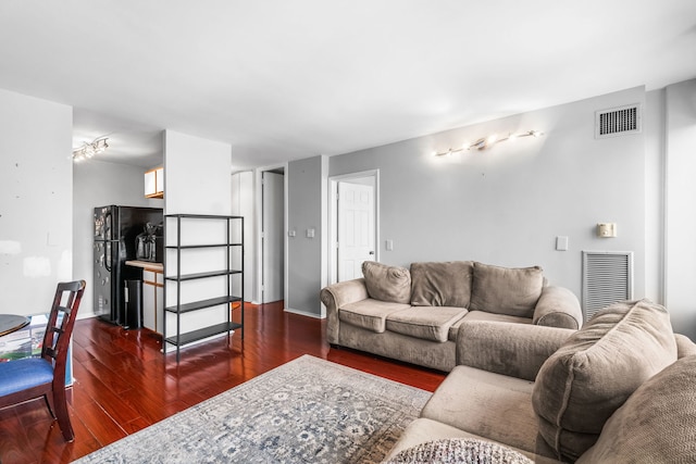 living room with dark hardwood / wood-style flooring