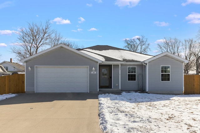 single story home featuring driveway, an attached garage, and fence