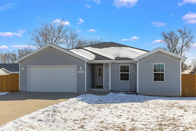 ranch-style house featuring concrete driveway, an attached garage, and fence