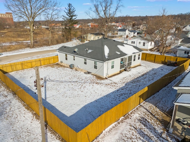 snowy aerial view featuring a residential view