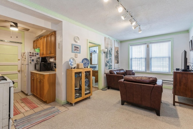 living room featuring rail lighting, crown molding, light carpet, a textured ceiling, and ceiling fan