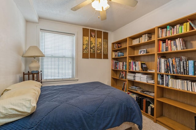 bedroom with ornamental molding, carpet floors, and a textured ceiling