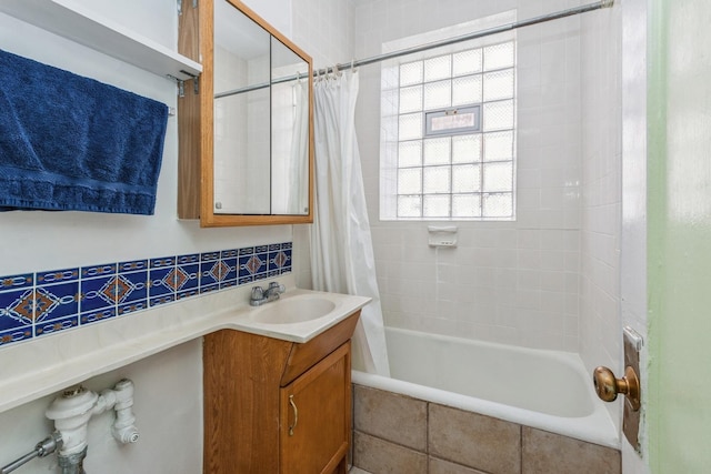 bathroom featuring tasteful backsplash, vanity, and shower / bath combination with curtain