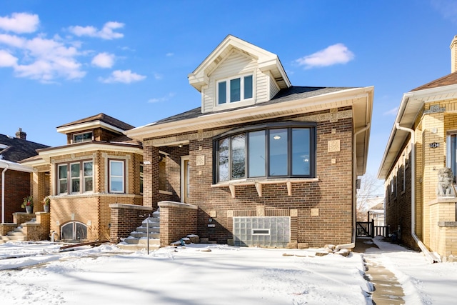 view of front of house with brick siding and stairway