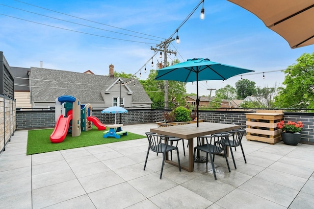 view of patio / terrace featuring outdoor dining space and a playground