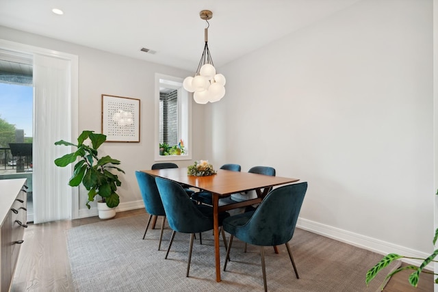 dining area featuring visible vents, baseboards, wood finished floors, and recessed lighting