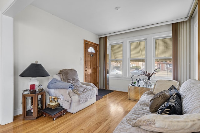 living area featuring light wood-style flooring and baseboards